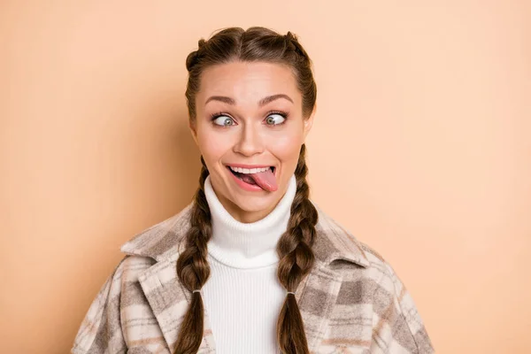 Portrait of nice hairstyle childish person squinting eyes tongue out wear plaid isolated on beige color background — Stock Photo, Image