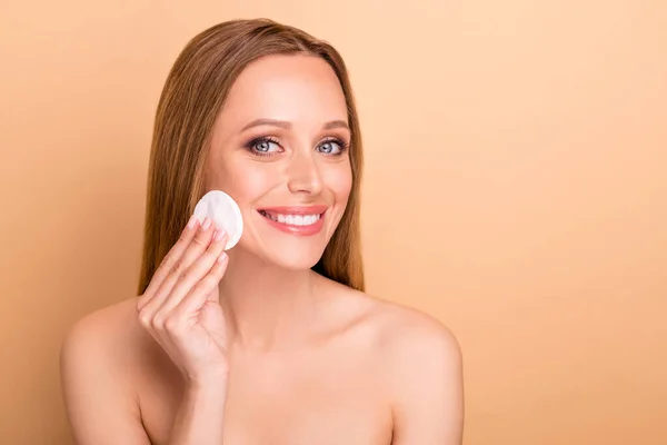 Close-up view portrait of her she nice-looking attractive lovely charming perfect cheerful nude naked girl cleansing pure soft silky skin natural tonic water isolated over beige pastel background