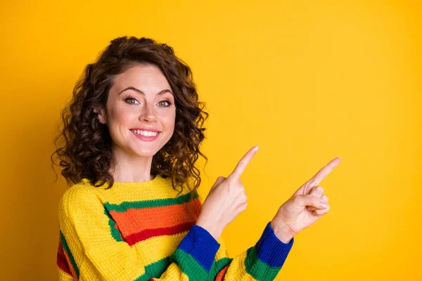 Kuva muotokuva iloinen tyttö osoittaa kaksi sormea tyhjä tila eristetty kirkkaan keltainen tausta — kuvapankkivalokuva