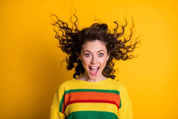 Foto de mulher surpreendida vestida casual moletom colorido vento soprando cabelo boca aberta isolado cor amarela fundo — Fotografia de Stock