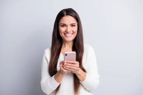 Retrato de encantadora chica morena alegre y confiada usando la aplicación gadget smm aislada sobre fondo de color pastel gris — Foto de Stock