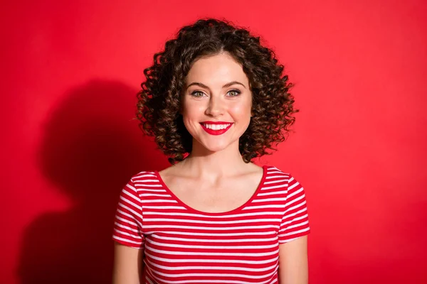 Photo de toothy mignon bouclé jeune dame porter casual rayé tenue sourire isolé fond de couleur rouge — Photo