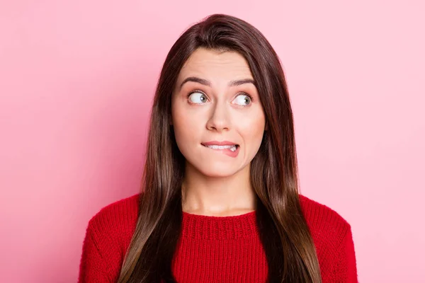 Portrait photo of troubled young girl with guilty face biting lip looking at side isolated on pink color background — Stock Photo, Image