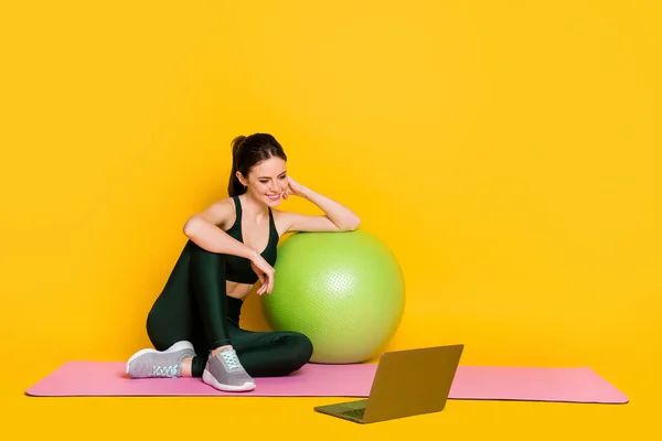 Full body size view of nice thin cheery sportive girl trainer watching online master class isolated on bright yellow color background — Fotografia de Stock