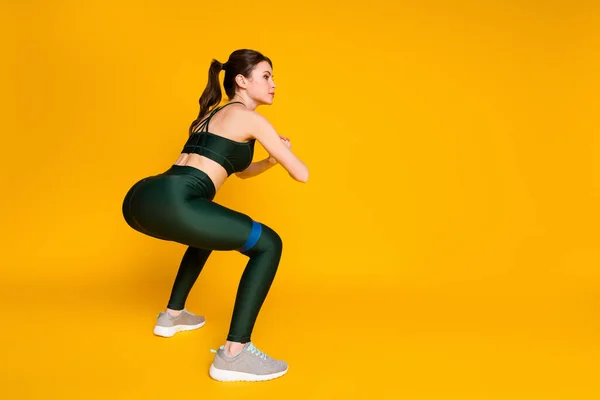 Photo of sporty lady butt workout stretch resistance rubber stripe wear sports suit isolated yellow color background —  Fotos de Stock