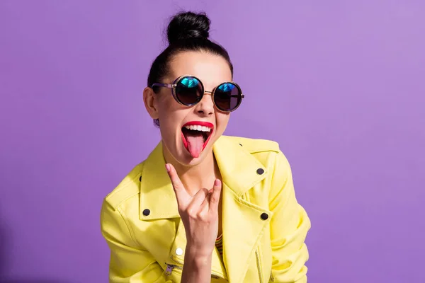 Photo of crazy youth girl show horns symbol stick-out tongue isolated over purple color background
