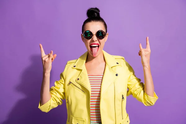 Photo of crazy youth girl show horns symbol stick-out tongue isolated over violet color background