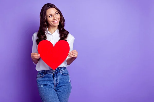 Foto de senhora bonita segurar símbolo do coração olhar espaço vazio desgaste camisa branca isolado cor violeta fundo — Fotografia de Stock