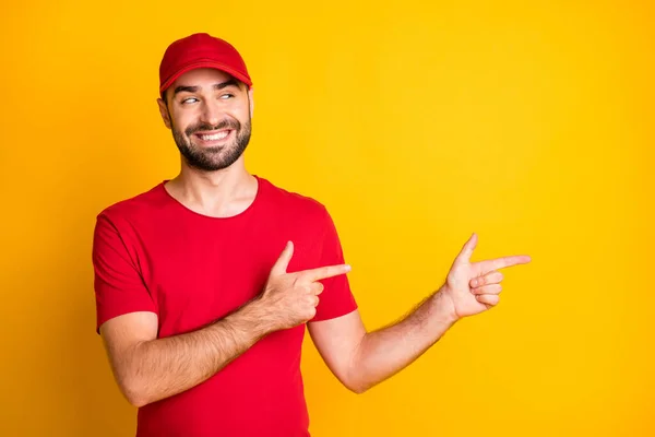 Portrait of nice curious cheerful content guy mailman demonstrating copy space advice isolated over bright yellow color background — Foto Stock