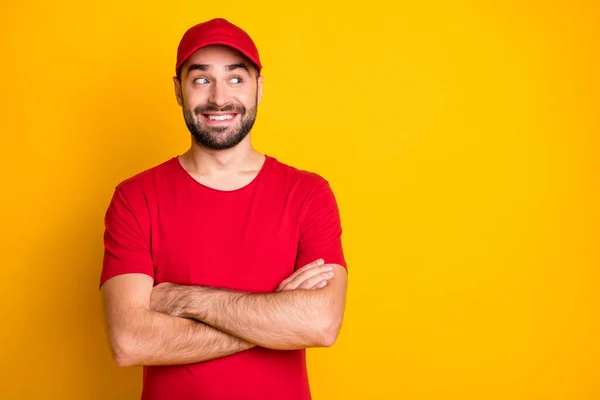 Portrait of nice funky content cheerful guy mailman folded arms looking aside copy space isolated over vibrant yellow color background — Foto Stock