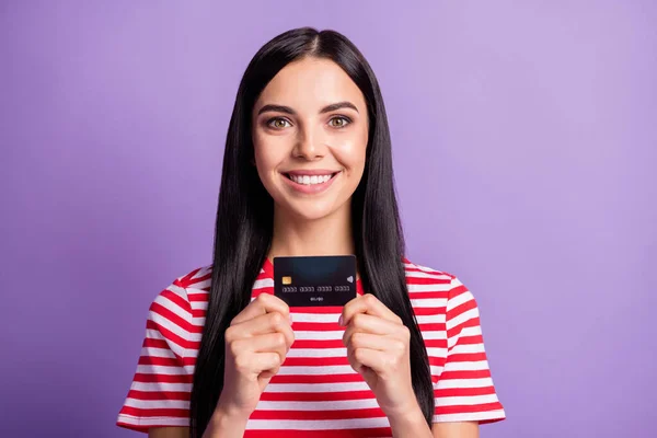 Photo of positive brown haired girl show credit card good mood salary isolated on violet color background