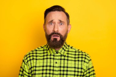 Portrait of attractive miserable unlucky devastated man wearing checked shirt isolated over bright yellow color background clipart