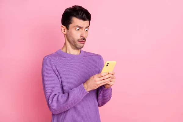 Portrait of attractive worried guy using device gadget app browsing post isolated over pink pastel color background — Zdjęcie stockowe