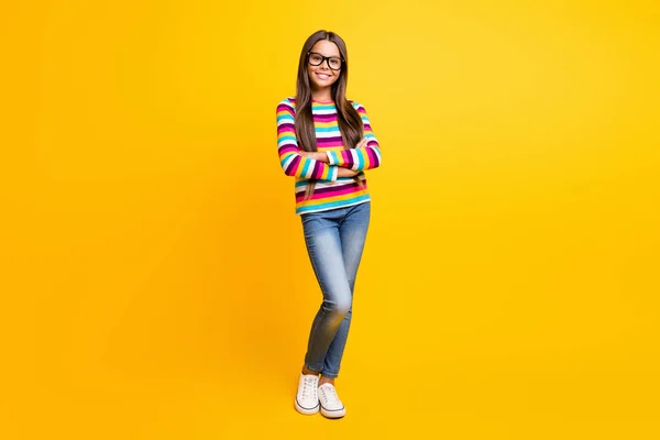 Full length body size photo of little girl long hair folded hands smiling wearing jeans jumper isolated on bright yellow color background — Stock Photo, Image