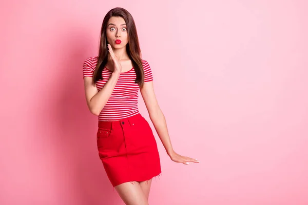 Photo of shocked charming young woman stand copyspace wear red striped t-shirt pouted lips isolated on pink color background — Stock Photo, Image