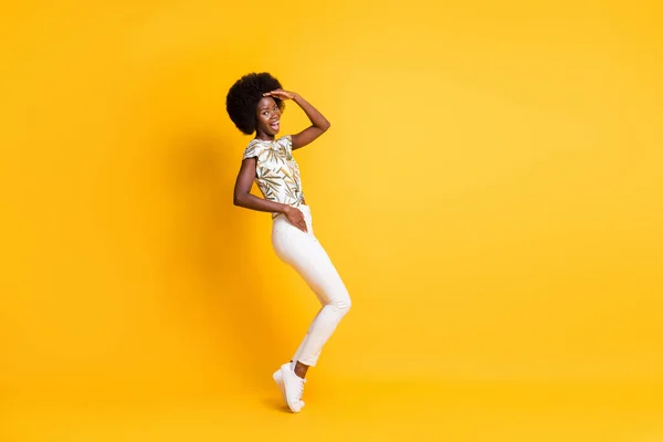 Full size profile photo of optimistic sweet curly hair lady dancing dress bright t-shirt sneakers trousers isolated on yellow background — Stock Photo, Image