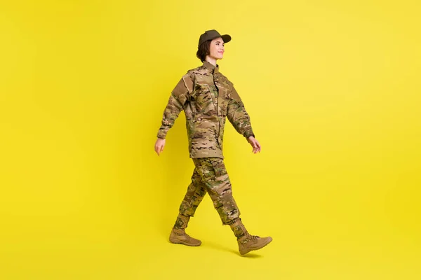 Foto de perfil de cuerpo completo de señora bastante satisfecha caminando mirada espacio vacío aislado sobre fondo de color amarillo — Foto de Stock