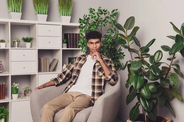 Photo portrait of young guy wearing spectacles plaid shirt sitting in armchair freelancer working from home — Stock Photo, Image