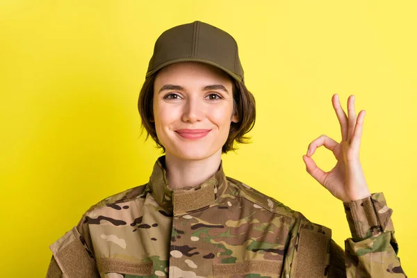 Photo of pretty friendly person smile fingers show okey approve symbol isolated on yellow color background