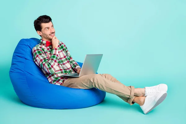 Profile photo of man sit bag use netbook look empty space wear plaid shirt bow pants isolated blue color background — Stock Photo, Image