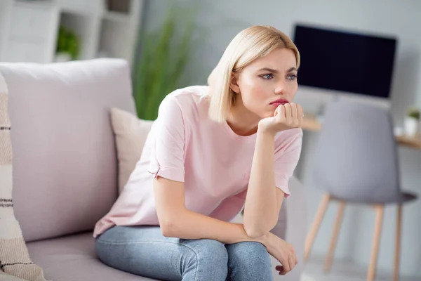 Photo of sad unhappy displeased young woman sit couch bad mood look away sit sofa indoors inside house home — Stock Photo, Image