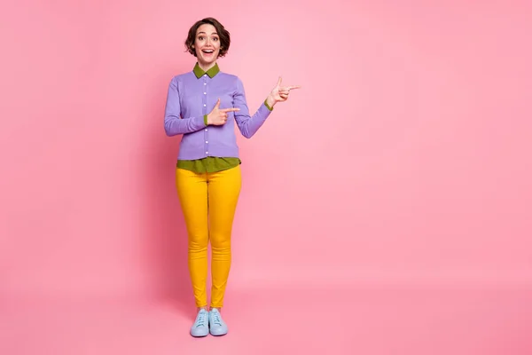 Full length photo of attractive lady student direct fingers empty space wear jumper pants shoes isolated pink color background — Stock Photo, Image