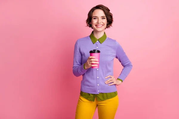 Photo of positive cheerful girl enjoy rest relax hold cappuccino cup wear pants isolated over pastel color background — Stock Photo, Image