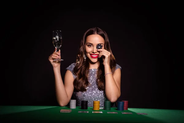 Zdjęcie pani siedzieć poker stół trzymać szklany szampan Chip okładka oko nosić błyszczącą sukienkę odizolowany czarny kolor tło — Zdjęcie stockowe