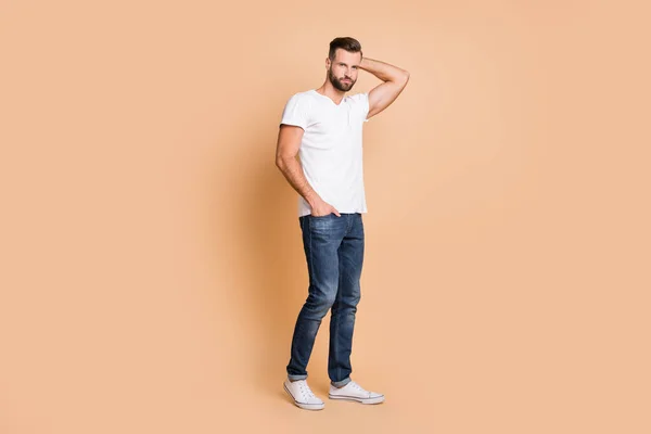 Full length body size view of attractive content macho guy posing wearing cozy clothes isolated over beżowy pastelowy kolor tła — Zdjęcie stockowe