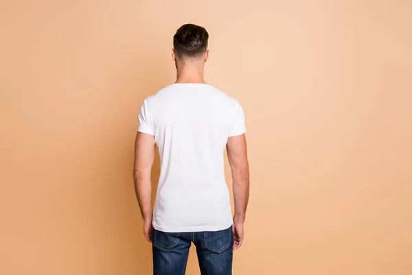 Back rear view photo of young brown hair man avoiding incognito anonym isolated over beige color background