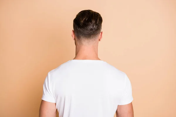 Rear back behind view portrait of nice attractive guy wearing modern haircut isolated over beige pastel color background — Stock Photo, Image