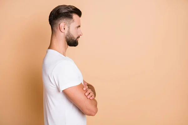Profile side view portrait of serious virile guy folded arms copy empty blank place space isolated over beige pastel color background — Stock Photo, Image