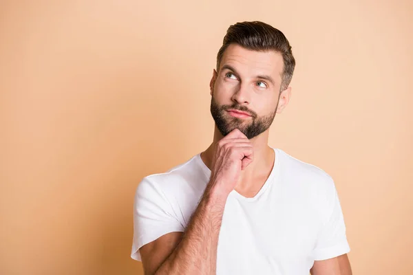 Photo of young handsome man dream dreamy curious look empty space hand touch chin isolated over beige color background — Stock Photo, Image