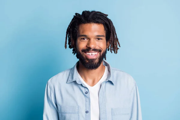 Portret van mooie aantrekkelijke vrolijke jongen hipster dragen jeans shirt geïsoleerd over helder blauw kleur achtergrond — Stockfoto