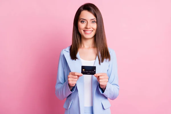 Foto de la joven feliz encantadora positiva sonriente linda mujer de negocios mantenga la tarjeta de crédito aislada en el fondo de color rosa — Foto de Stock