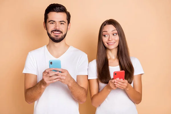 Foto di due persone attraente signora guardare bello schermo del telefono ragazzo isolato su sfondo di colore beige — Foto Stock