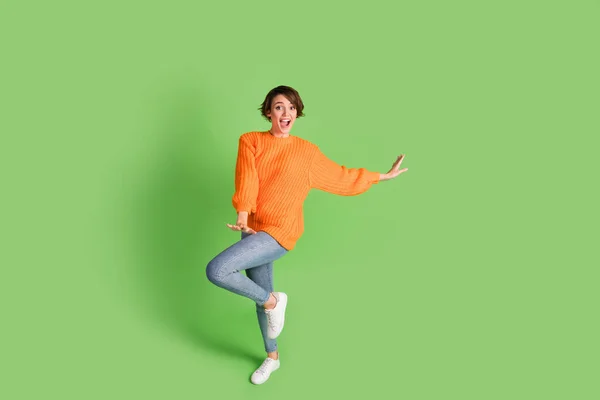 Full length photo of excited charming young lady happy funky dance weekend isolated on green color background — Stock Photo, Image