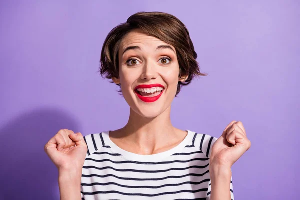 Portrait of funky cute short brunette hairdo girl yelling hands fists wear stripped pullover isolated on violet color background — Stock Photo, Image