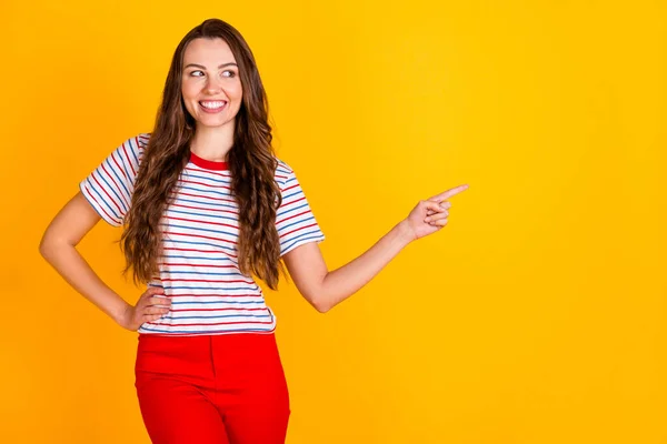 Porträtt av attraktiv glad flicka visar kopia tomt utrymme annons välj erbjudande isolerad över levande gul färg bakgrund — Stockfoto