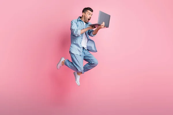 Full length body size photo of jumping programmer amazed working on laptop isolated on pastel pink color background — Stock Photo, Image