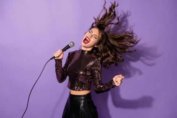 Portrait of attractive popular cheerful girl having fun singing single rock hit isolated over bright violet color background — Stock Photo, Image