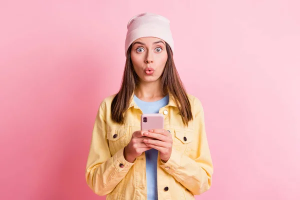 Retrato de mãos muito jovens segurar telefone inacreditável reação lábios isolados no fundo cor-de-rosa — Fotografia de Stock