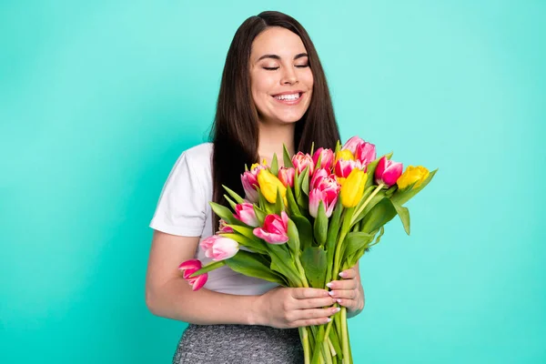 Neşeli genç kızın fotoğrafı mutlu bir gülümseme doğum günü hediyesi çiçek buketi turkuaz renkli arka planda izole edilmiş. — Stok fotoğraf