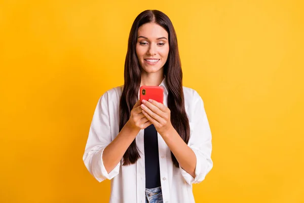 Photo of charming young lady typing blog post toothy smile isolated on vibrant yellow color background — Stock Photo, Image