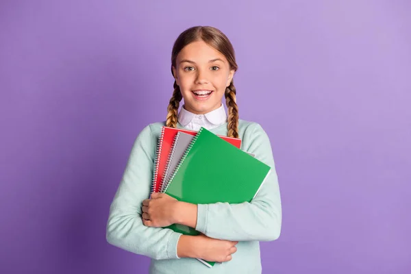 Photo of small excited lady hold pile notebooks look camera wear green sweater isolated violet background — Stock Photo, Image