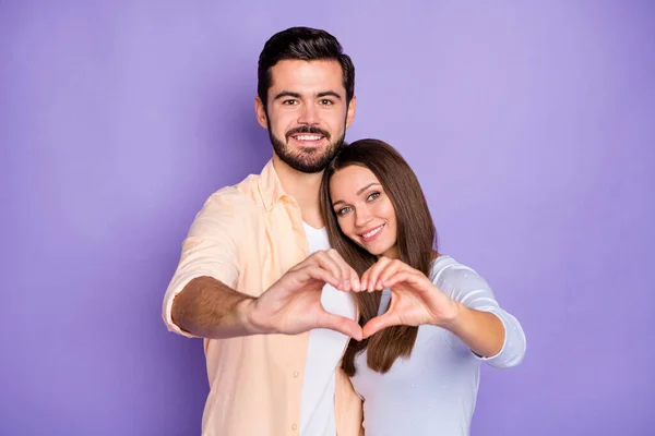 Photo of bristled brunette man charming woman make hands heart figure hug honeymoon isolated on violet color background — Stock Photo, Image