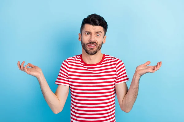 Foto de infeliz joven dudoso encogiéndose de hombros cara mueca despistado aislado sobre fondo de color azul pastel — Foto de Stock