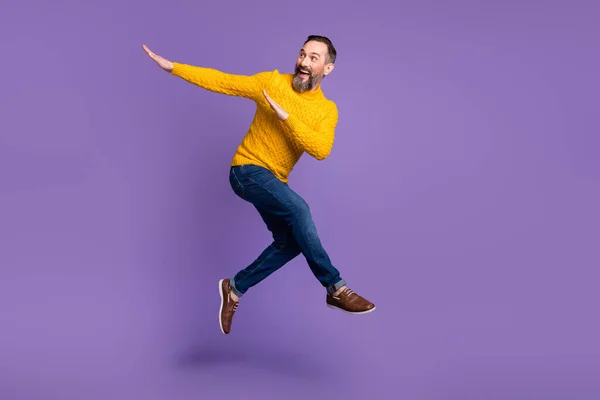 Full body profile portrait of energetic man look empty space arms dabbing isolated on purple color background