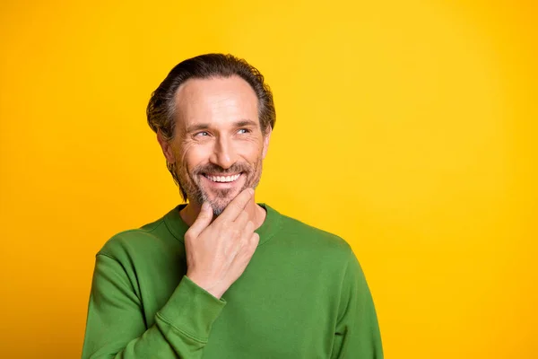 Foto de mente positiva homem dedo queixo olhar vazio espaço desgaste verde suéter isolado vívido cor amarela fundo — Fotografia de Stock