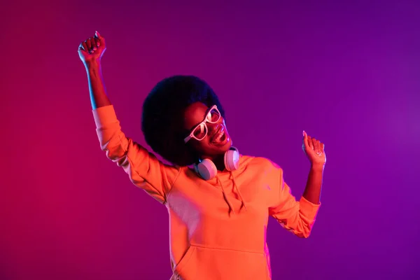 Foto de señora divertida loca danza cantar usar sudadera auriculares gafas gradiente aislado fondo oscuro — Foto de Stock